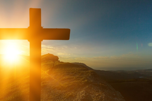 Christian cross with on sunset background. Christ concept