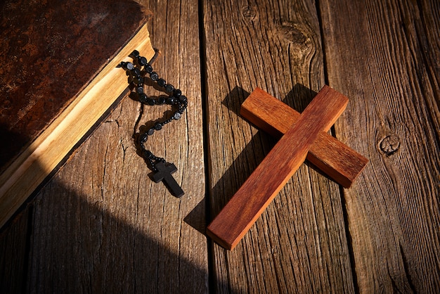 Christian cross on wood bible and rosary