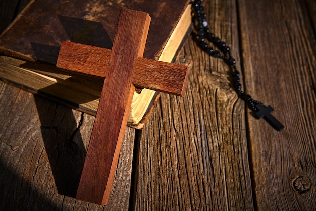 Christian cross on wood bible and rosary