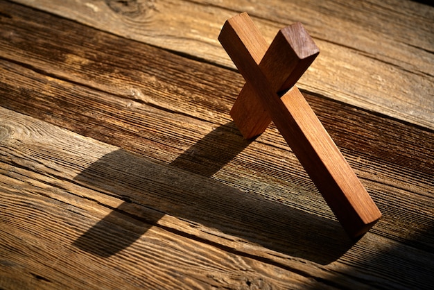 Christian cross on wood over wooden