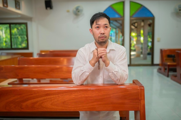 Christian man asking for blessings from GodAsian man praying to Jesus Christ