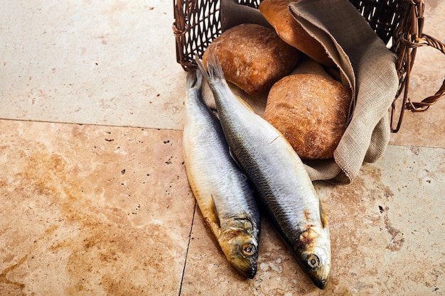 Christianity background loaves of bread and two fish in a basket