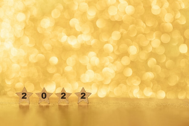 Foto sfondo astratto di natale e capodanno 2022 con bokeh luccicante oro lucido