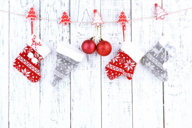 Christmas accessories hanging on white wooden wall