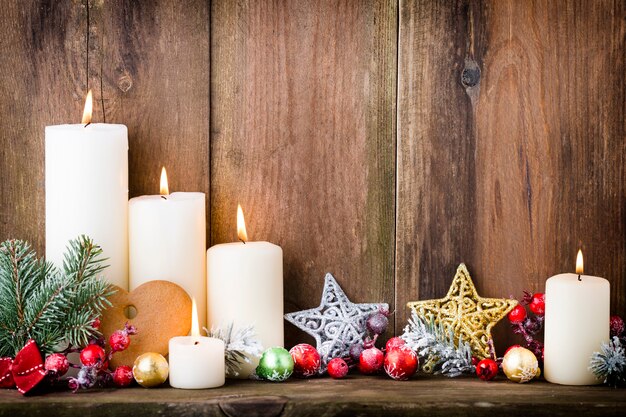 Christmas Advent candles with festive decor.