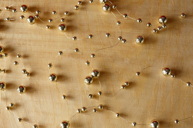 Christmas background Beads on a light wooden background