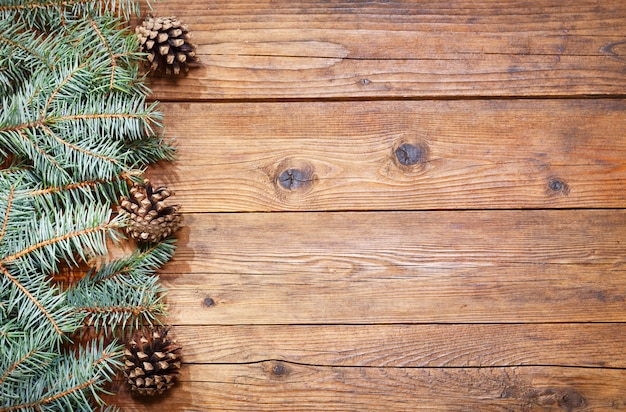 Christmas background. Christmas decoration with fir branches on wooden background, top view