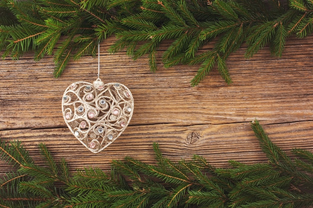 Christmas background. Christmas fir tree with Christmas tree toy on old wooden board background