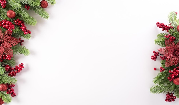 Christmas background concept. Top view of spruce branches, flower  and berries on white background.