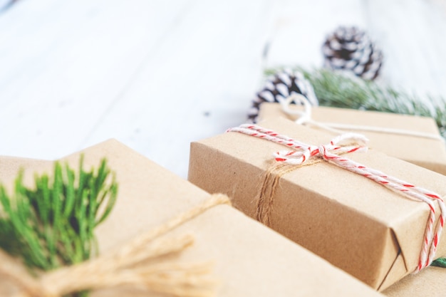 Christmas background - Craft and handmade Christmas present (gift boxes) and rustic decoration. Vintage style. Selective focus and shallow.