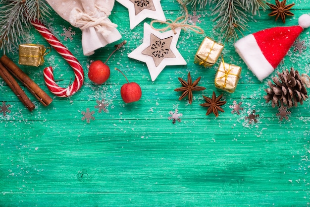 Christmas background,  decorations on emerald  wooden desk, flat lay style