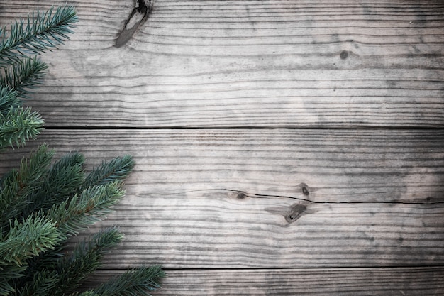 Christmas background - fir tree decorating rustic elements on vintage wood table. Creative Flat layout and top view composition with border and copy space design.