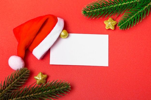 Christmas background. Flat christmas mockup with blank copy business card and santa claus hat