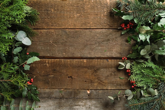 Christmas background Fresh branches on wooden backdrop copy space