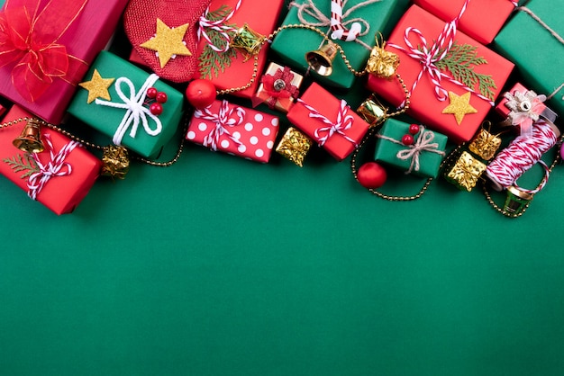 Christmas background, gift box with socks decoration on green background.