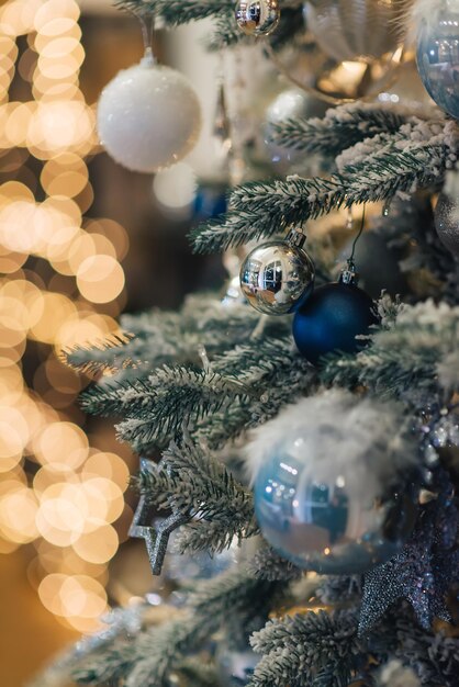 Christmas background, green pine branches with cones and Christmas balls