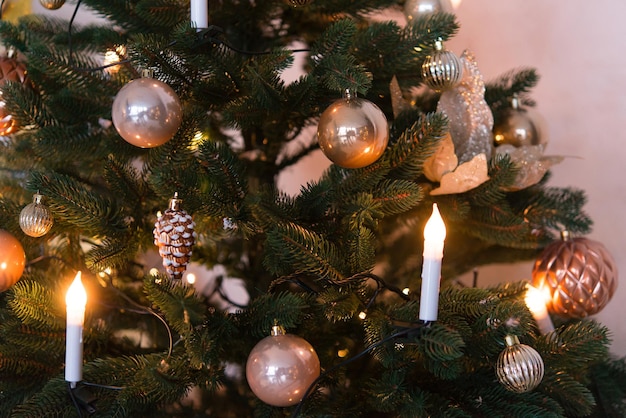 Christmas background, green pine branches with cones and Christmas balls