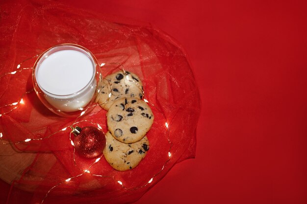 Christmas background red with cookies and milk and lights