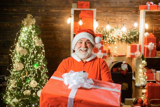 Christmas background santa with present box december bearded santa claus man in santa costume