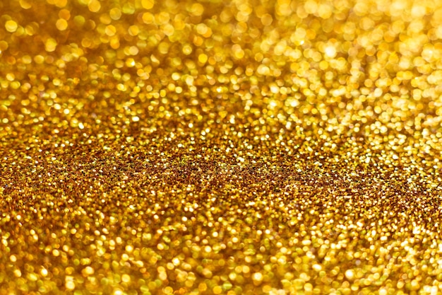 デフォーカス ボケ味を持つ光沢のある黄金のクリスマス背景