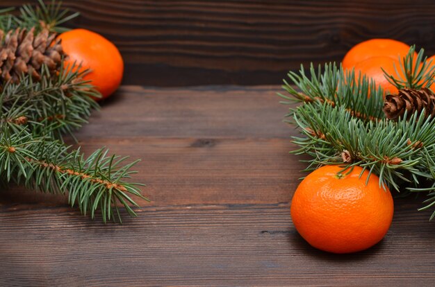 Christmas background, tangerines and spruce branches, copy space, place for object, rustic style