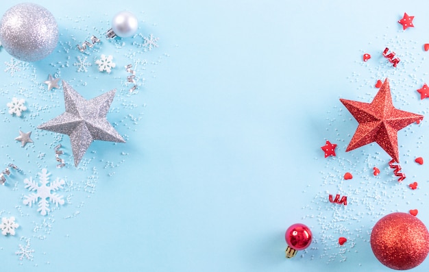 Photo christmas background. top view of christmas decoration with snowflakes on light blue pastel background. copy space.