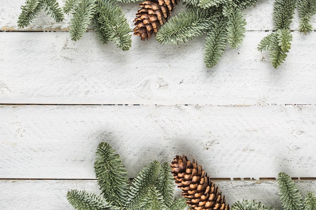 Christmas background twigs and pine cone on wooden background - Top of view.