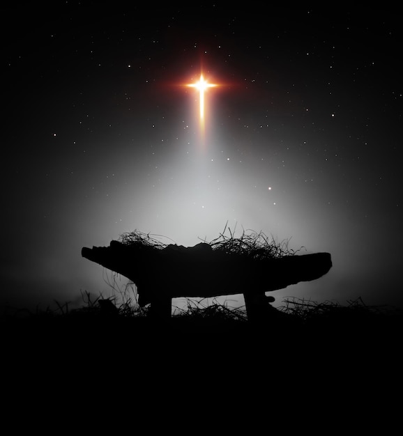 Photo christmas background with bright cross shaped big star and baby jesus birth in manger