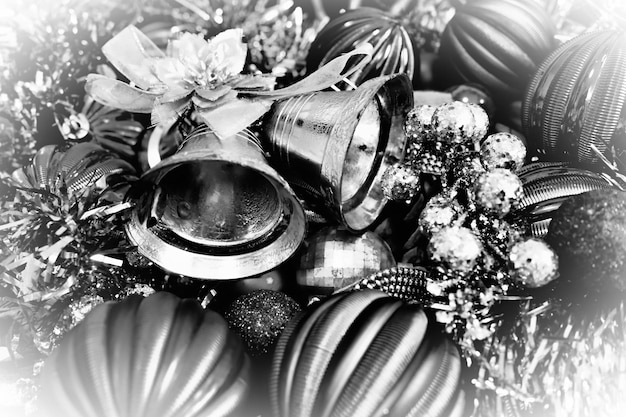 Фото Новогодний фон с елочными украшениями праздничные шары колокольчики бантики новогодняя мишура happy new year and merry christmas черно-белое монохромное фото ретро винтажный стиль белая виньетка