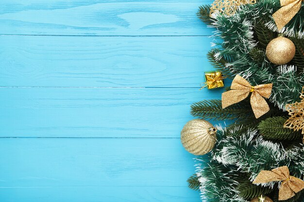 Christmas background with decorations and gift boxe on blue wooden board. Top view.