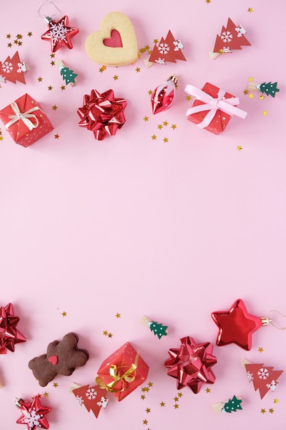 Christmas background with decorations and gift boxes on PINK