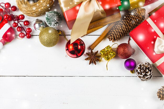 Christmas background with decorations and gift boxes on wooden board