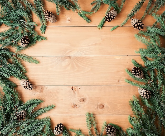 Christmas background with decorations and gift boxes on wooden board