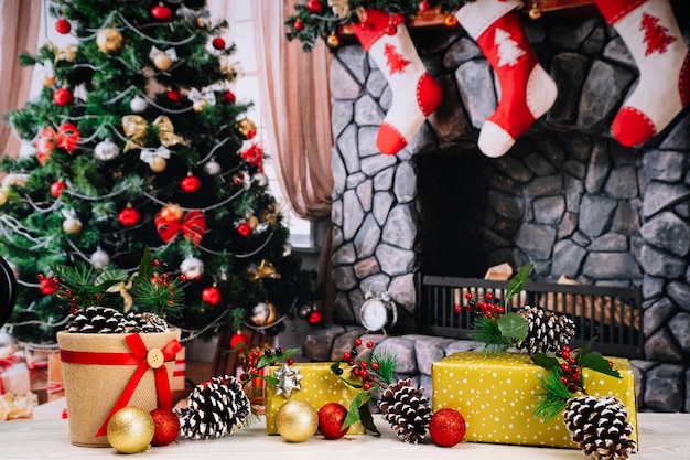 Christmas background with gifts, pine cones and tree