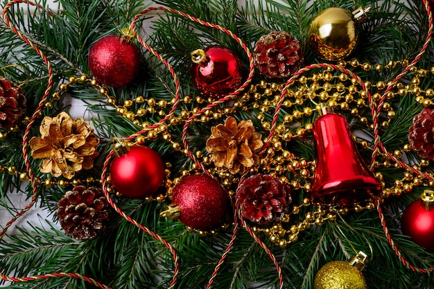 Christmas background with golden Christmas beads and red ornaments 