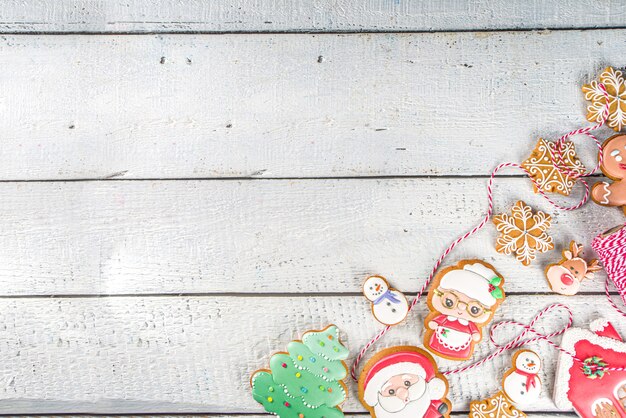 Christmas background with homemade gingerbread cookies. Traditional winter festive baking, Flat lay, om white wooden background copy space.