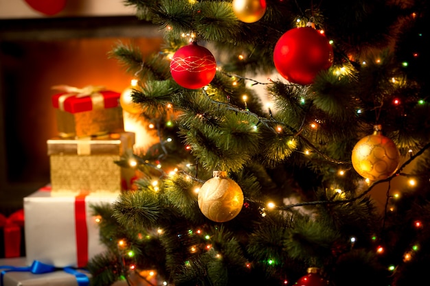 Christmas background with illuminated fir tree and fireplace at house