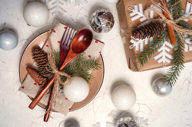 Christmas background with new year decorations and set table spoon and fork gift on a black chalk bo...