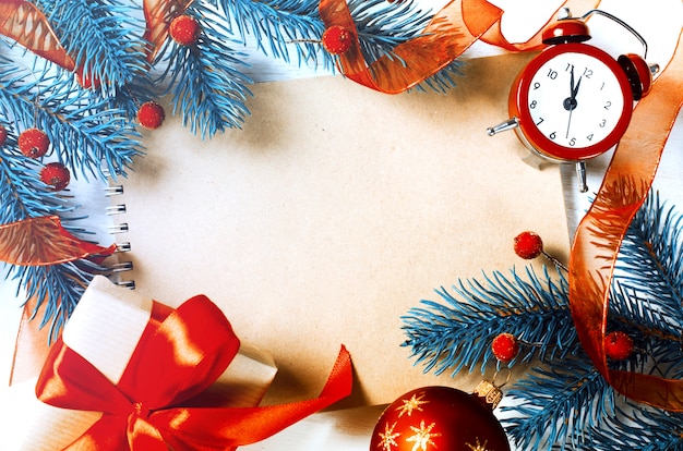 Christmas background with notebook and clock.