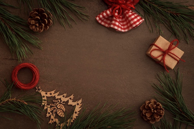 Christmas background with pine branches cones and gifts