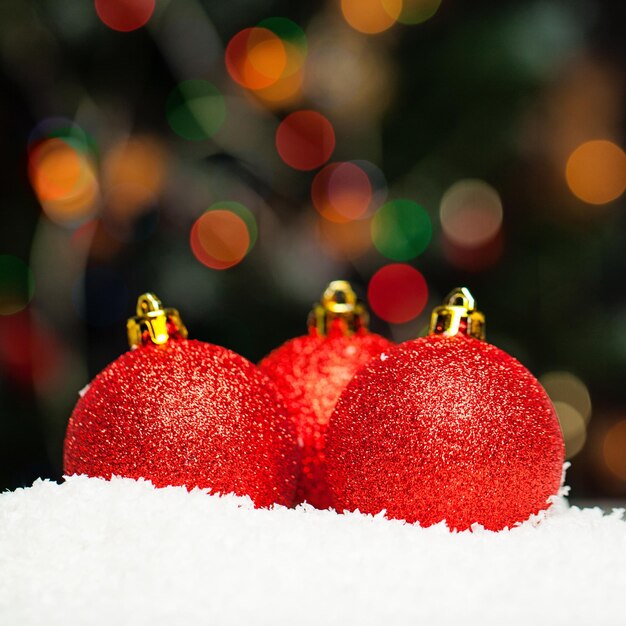 Christmas background with red baubles and abstract bokeh light