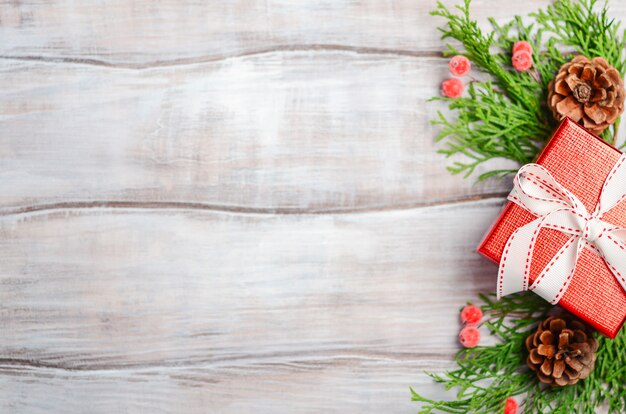 Christmas background with red gift box on a wooden background