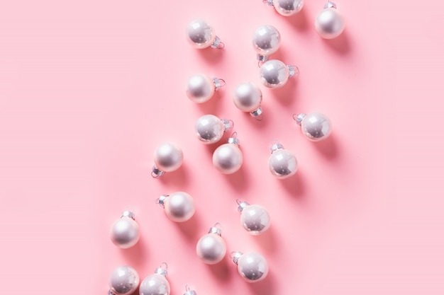 Christmas background with silver balls on pink