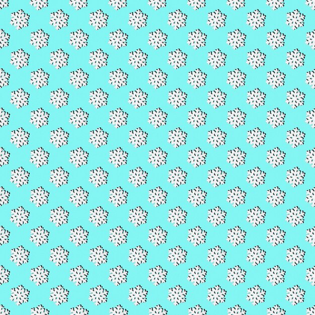 Christmas background with snowflakes. Festive seamless pattern of white snowflakes on a light blue background. Can be used as Christmas and New Year cards, design backing, textiles, wrapping paper