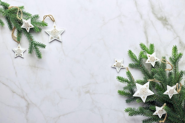 Christmas background with tree and decorative ornaments in the\
form of stars flat lay top view