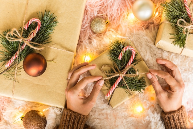 Christmas background with woman hands and gift boxes