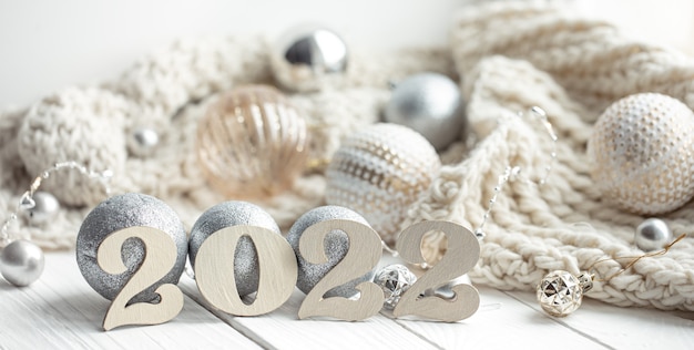 Christmas background with wood 2022 numbers and decor details.