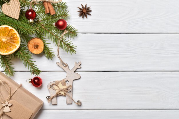 Christmas background with a wooden deer on a wooden white background.