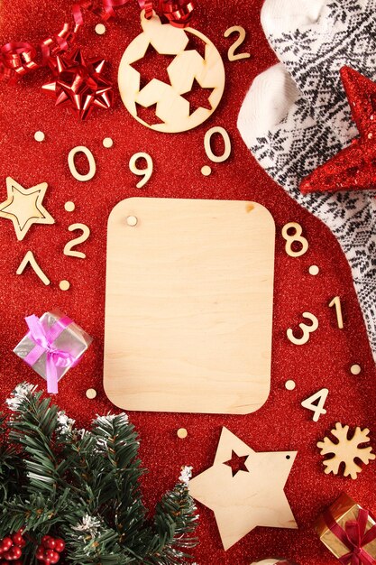 Christmas background. Wooden background with fir branches, pine cones, red berries and place for text.