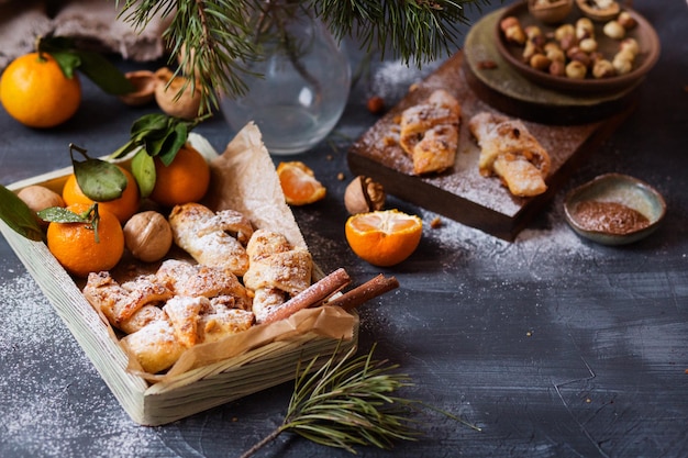 Christmas bagels with nuts and cinnamon  Croissants Tangerines pastries Hazelnuts and walnuts